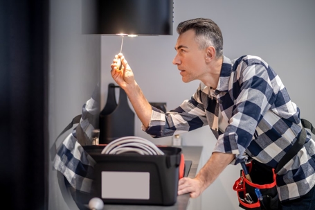 electrician checking light on lamp